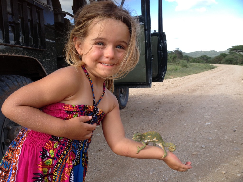 Halina holds a chameleon on the road to Amboseli.